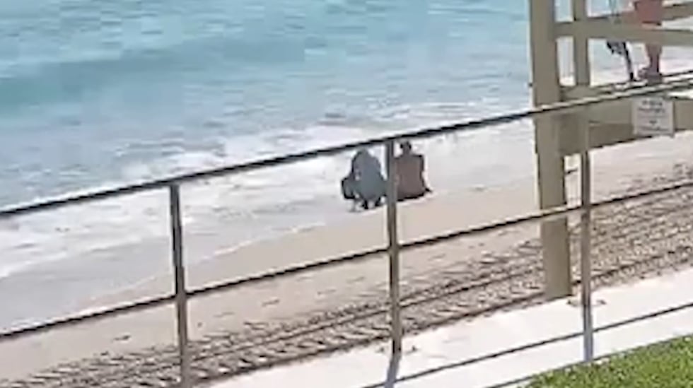 Video released by police shows Belinda stooping beside a man believed to be double homicide...