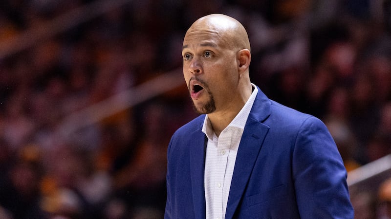 Wofford coach Dwight Perry directs players during the first half of the team's NCAA college...