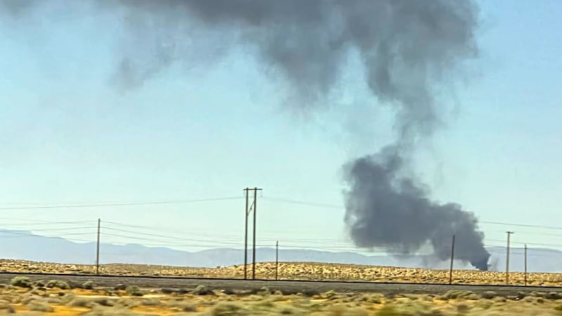 Smoke plumes rise from a B-52 bomber that crashed shortly after takeoff at a U.S. Air Force...
