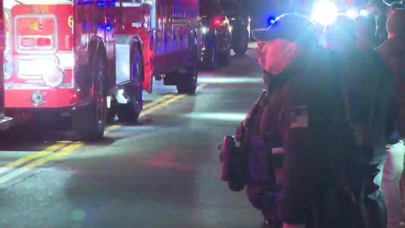 Local and federal law enforcement agencies line alongside the procession for the dignified...